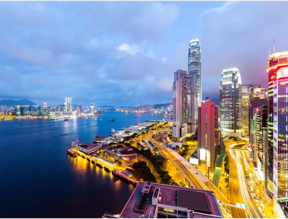 skyscrapers in hong kong at night against victoria harbour