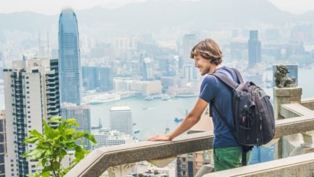 man looking at view of hong kong