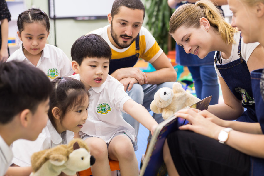 native english teachers reading a storybook to children at good time international play school and kindergarten