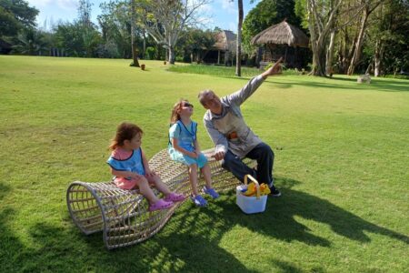 two children and a teacher at a guidepost montessori summer camp in bali