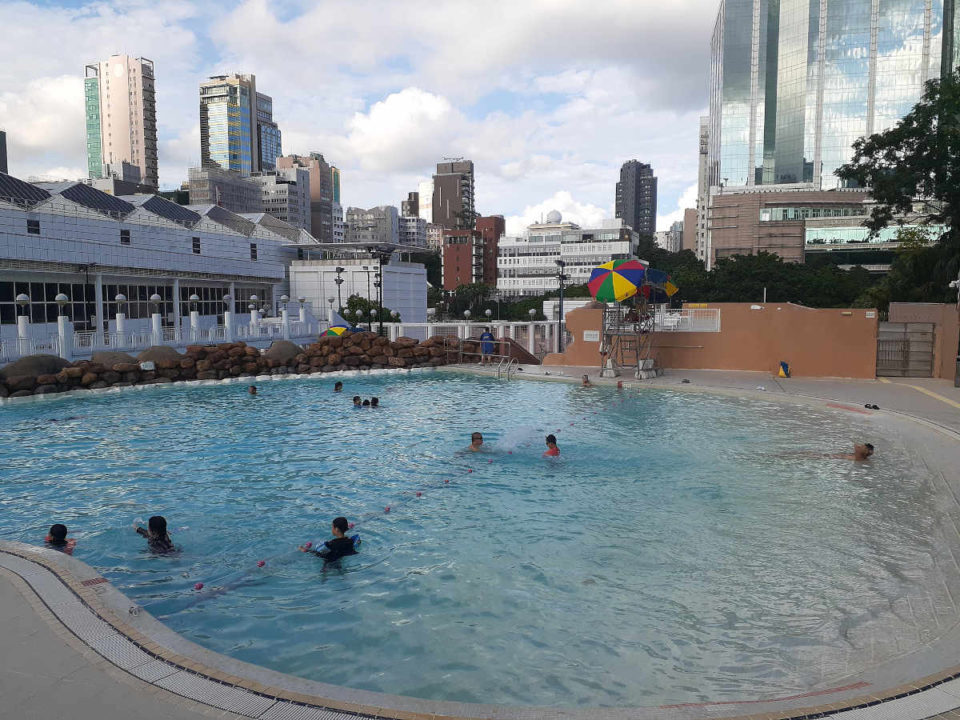 swimmers relaxing in one of the pools at kowloon park swimming pool