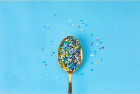 multicoloured microplastics on a spoon