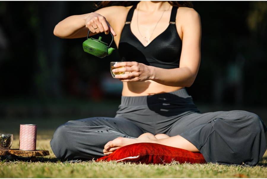 woman pouring tea as part of tea meditation