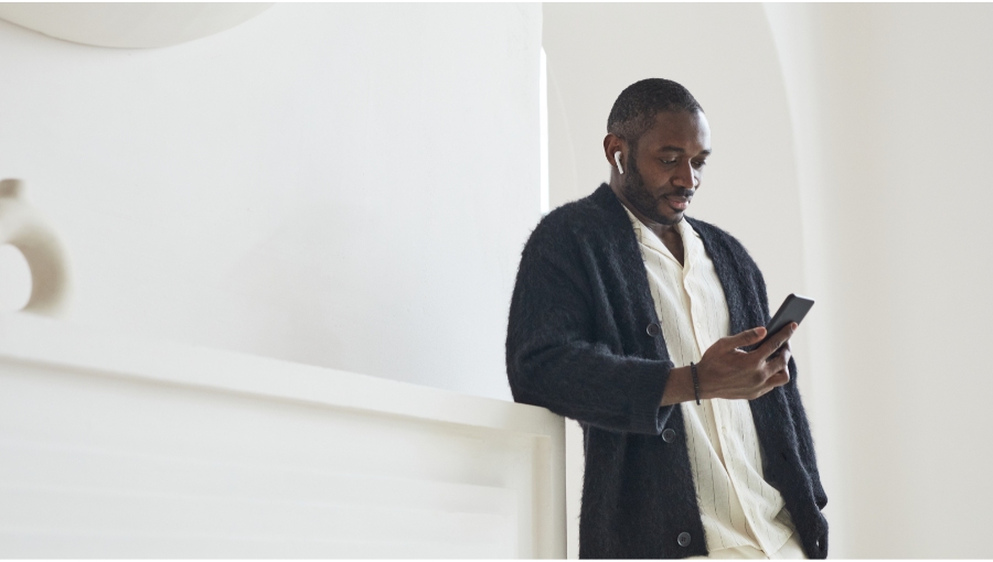 man looking down at his phone