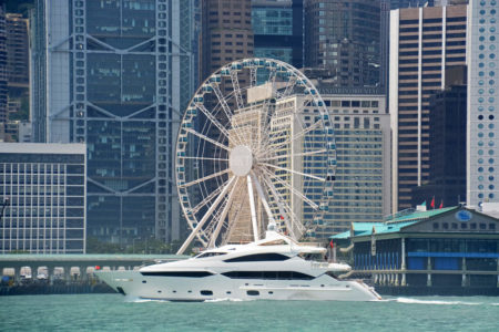 yacht speeding past hong kong observation wheel